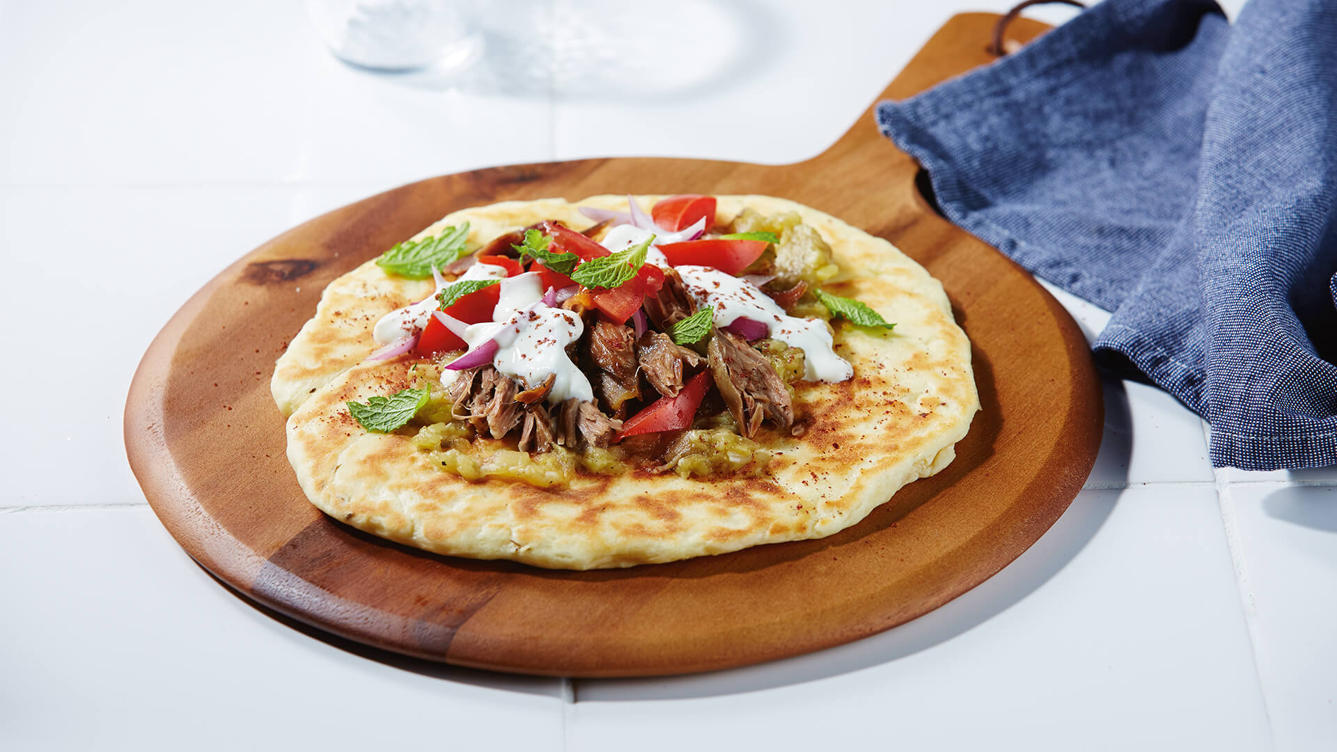 Slow cooked lamb on yoghurt flatbreads with eggplant puree Bulla